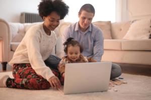 mom and dad with toddler using computer
