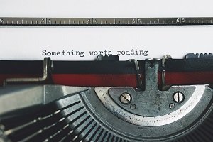 typewriter that reads 'something worth reading'