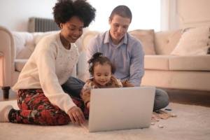 mom and dad with toddler using computer