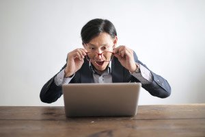 Man excited about what he sees on his computer